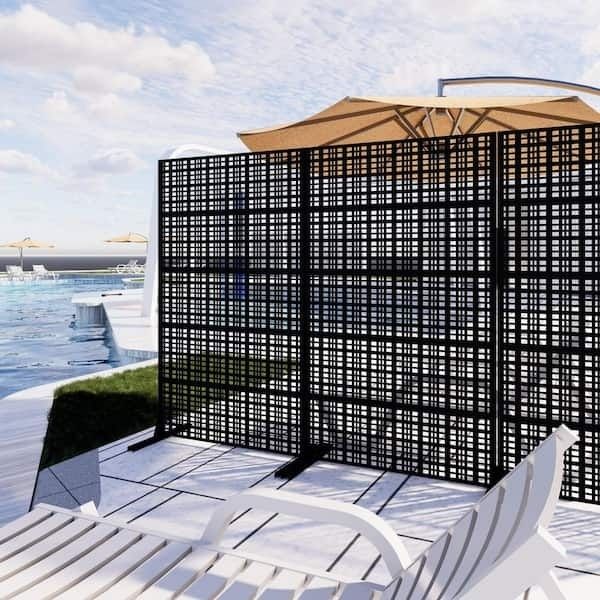 Freestanding black lattice trellis dividing a poolside patio