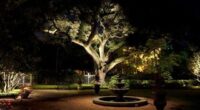 Night-lit backyard tree canopy above a fountain and brick patio
